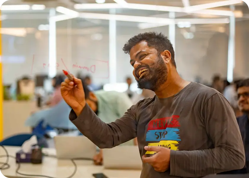 A developer working through an idea on the glass wall